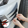 Person applying carbon fiber pattern car sticker to a vehicle's side panel.