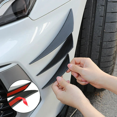 Person applying carbon fiber pattern car sticker to a vehicle's side panel.